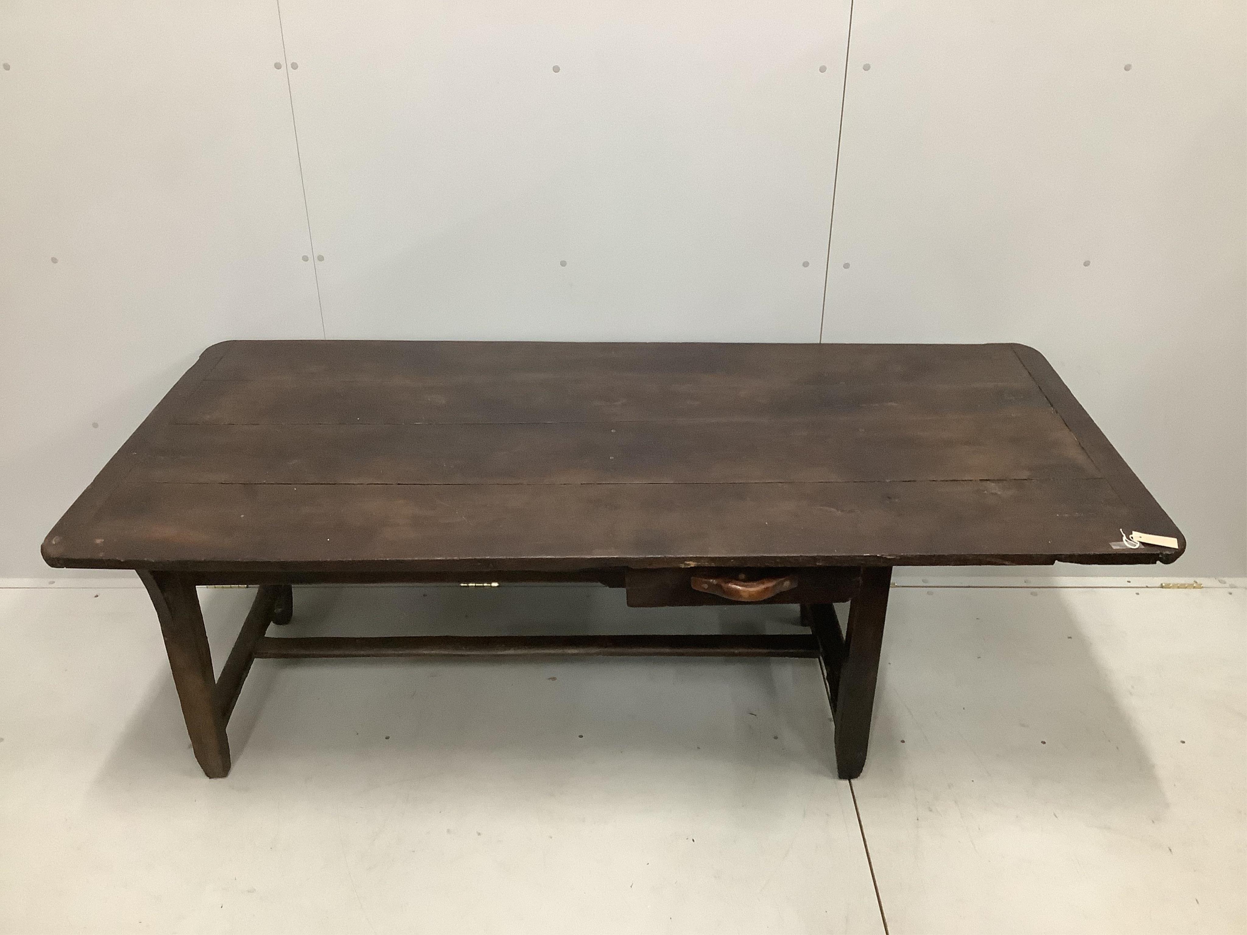 A 19th century French oak plank top kitchen table, width 198cm, depth 92cm, height 71cm, together with a pair of 19th century French oak benches, length 200cm, depth 24cm, height 42cm. Condition - fair